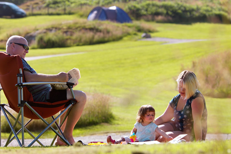 Family enjoying picnic outside tent