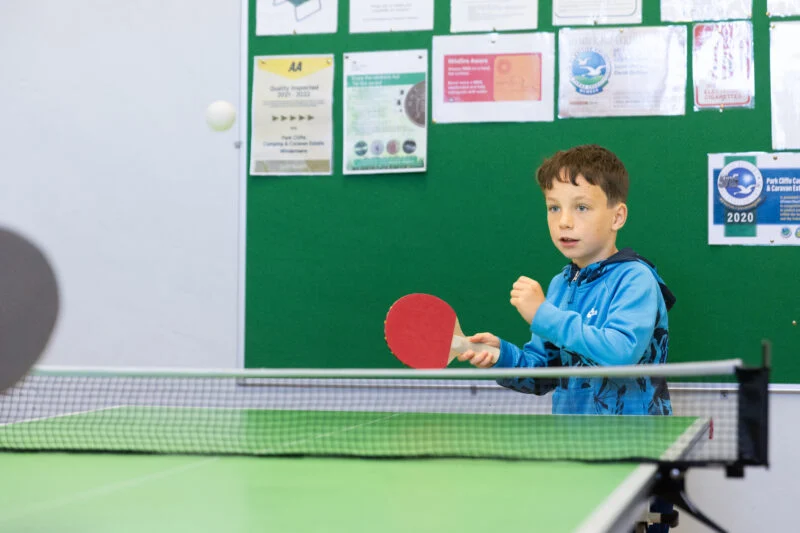 Little boy playing table tennis