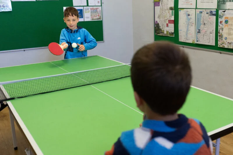 Kids playing ping pong Park Cliffe Lake District