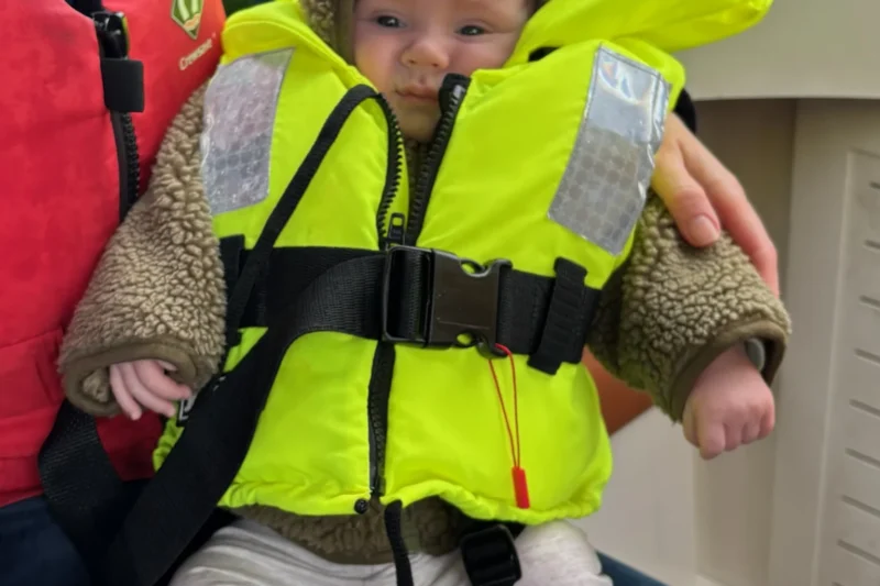 baby in life jacket on lake district boat