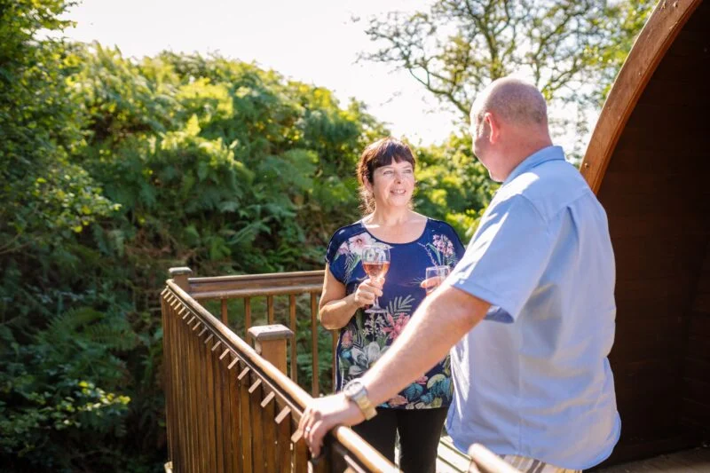 camping pod balcony couple wine Lake District