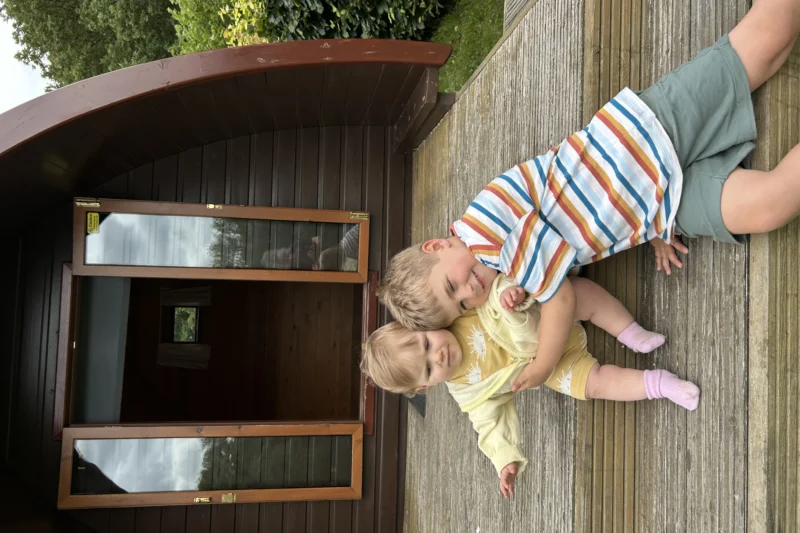 children on glaping pod decking