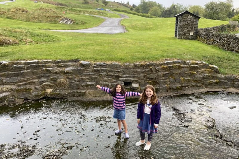 girls walking in the river