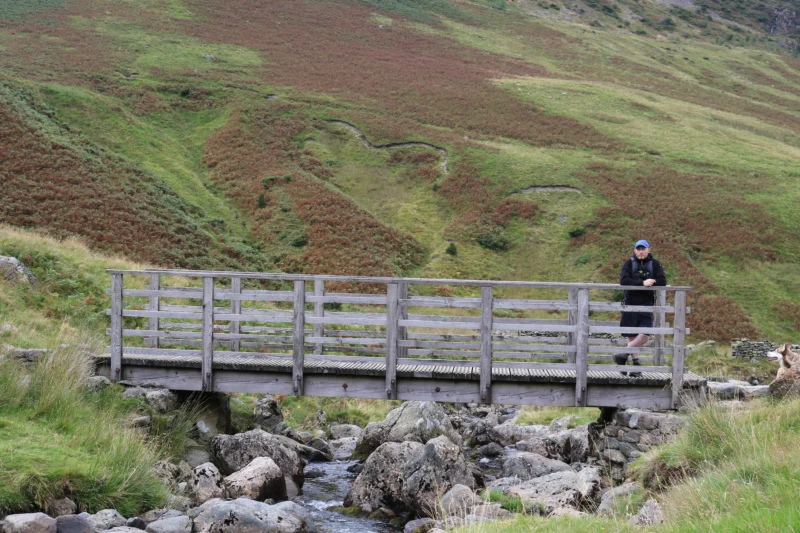 man stood on lake district bridge