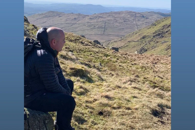 man admiring views sat down