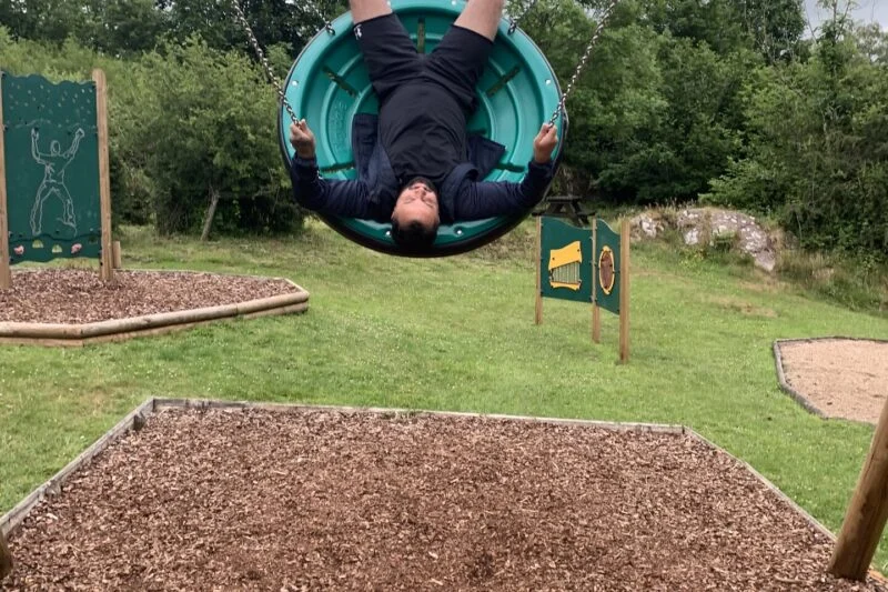 man on the swing at park cliffe playground