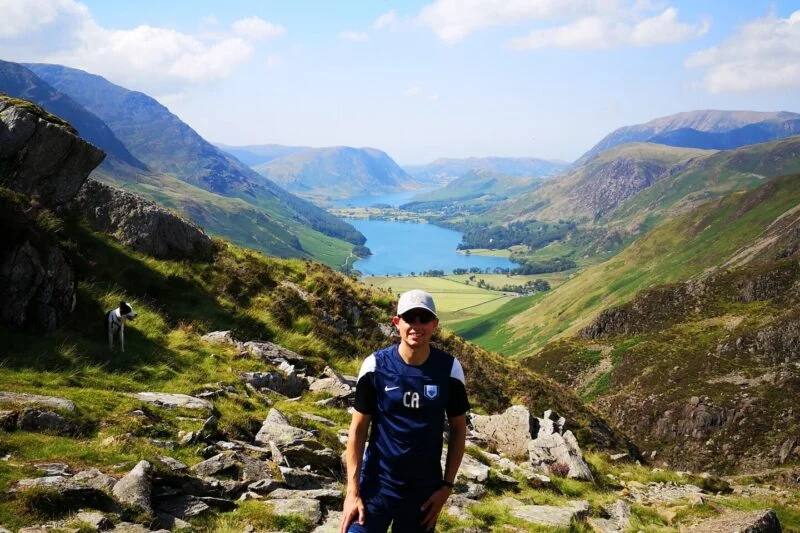 man posing with views lake