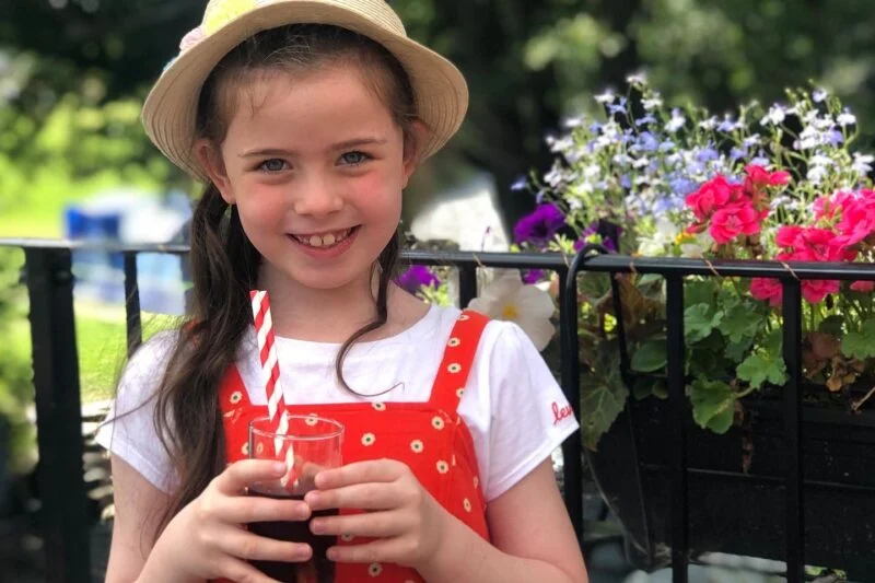 child enjoying a drink at park cliffe
