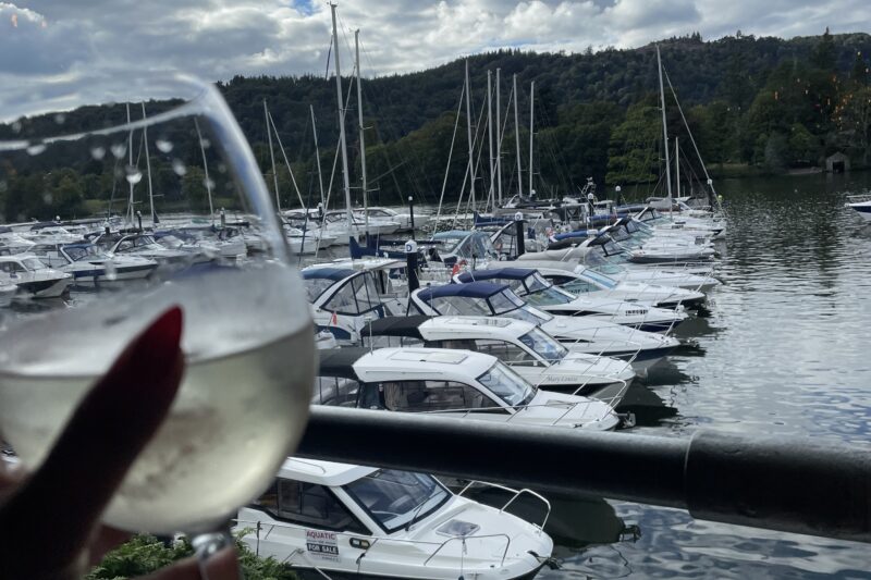 enjoying a glass of wine overlooking marina lake district