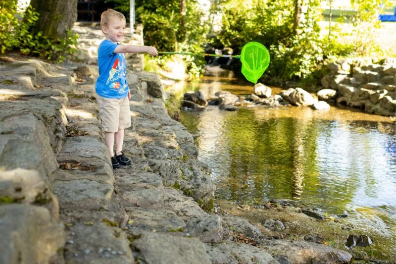 Child fishing at Park Cliffe river facility