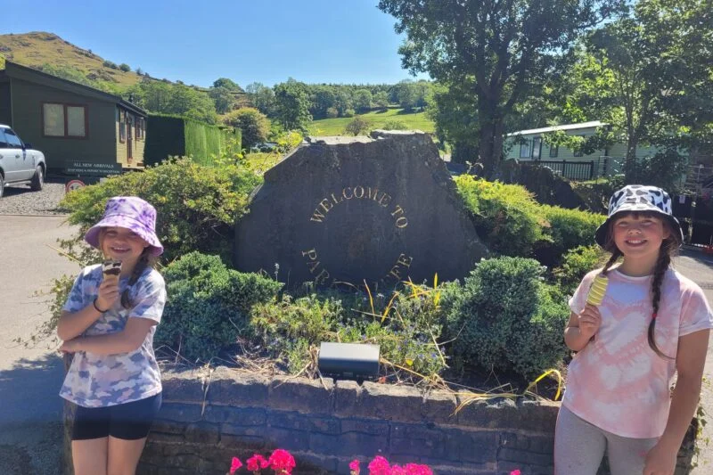 girls having ice cream by park cliffe logo on stone