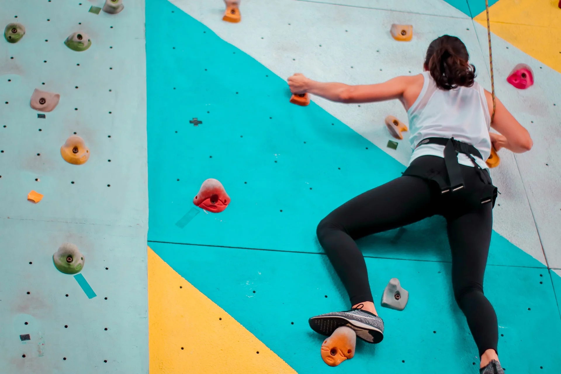 woman climbing indoor wall