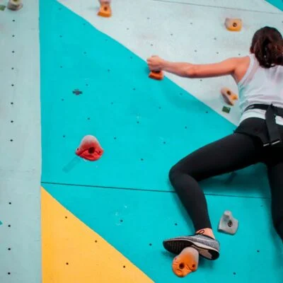 woman climbing indoor wall