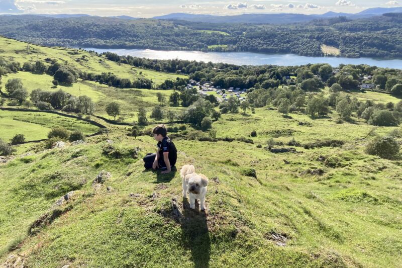 boy and dog in fells above lake district