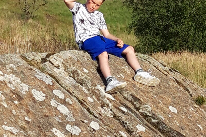 boy sat on rock at park cliffe caravan park