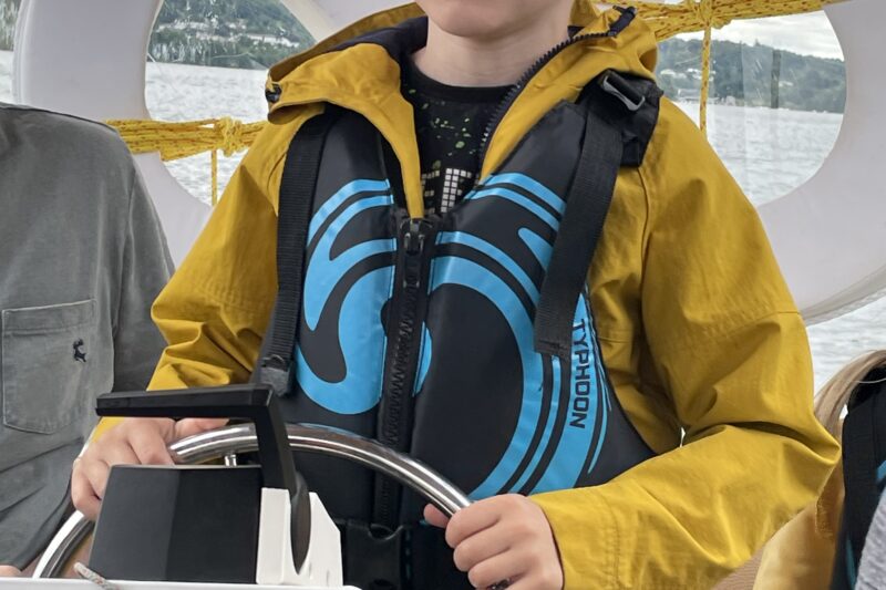 boy driving boat lake district