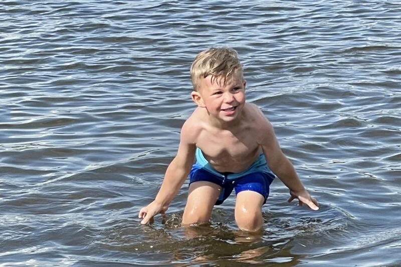 child paddling in the lake district