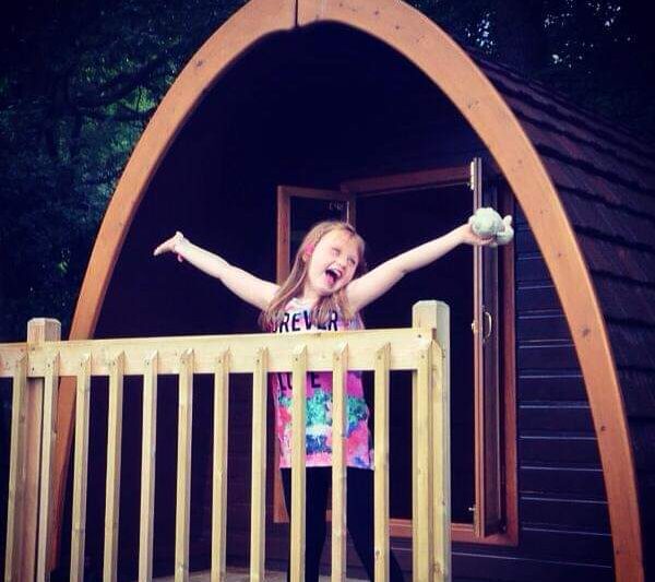 child happy outside of glamping pod