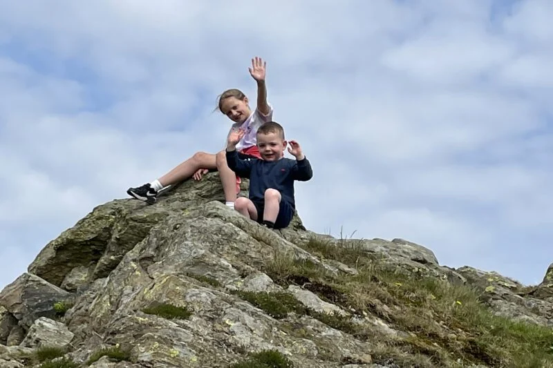 children climbing rocks lake district campsite