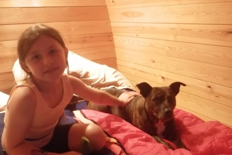 dog and girl in glamping pod park cliffe
