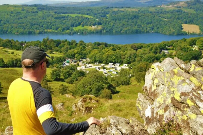 man looking over the lake district