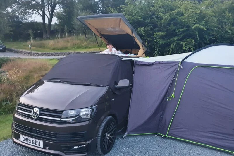 boy on top of campervan roof tent