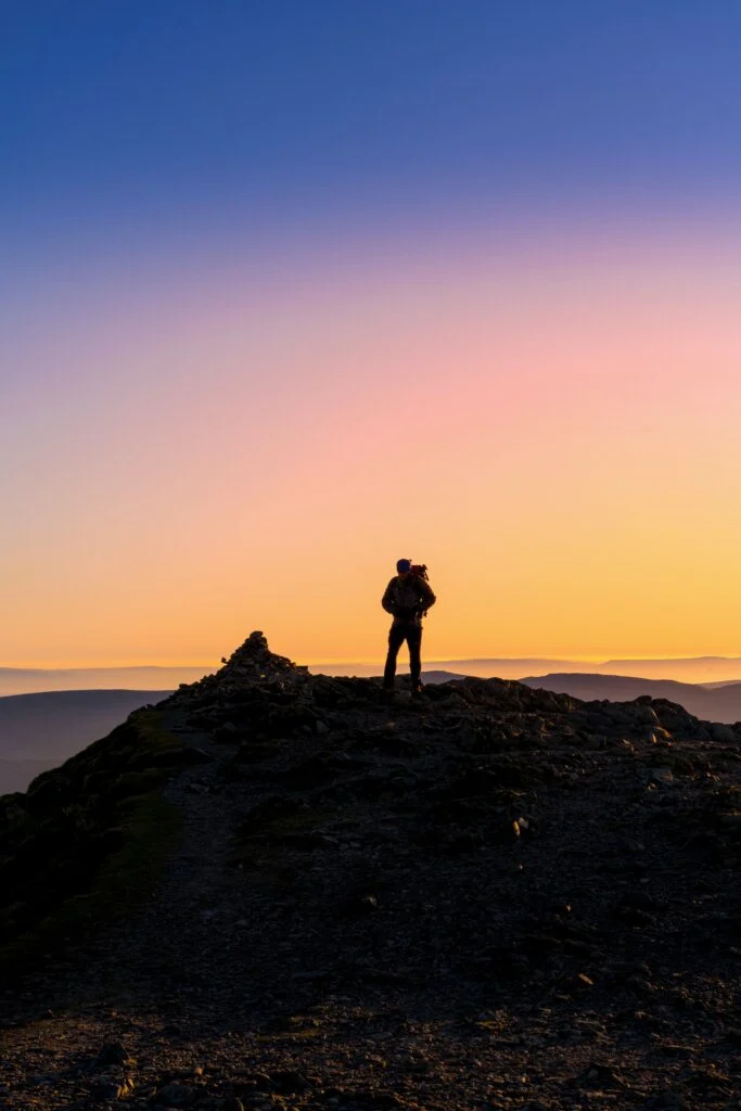 man standing in front of sunset at Helvellyn