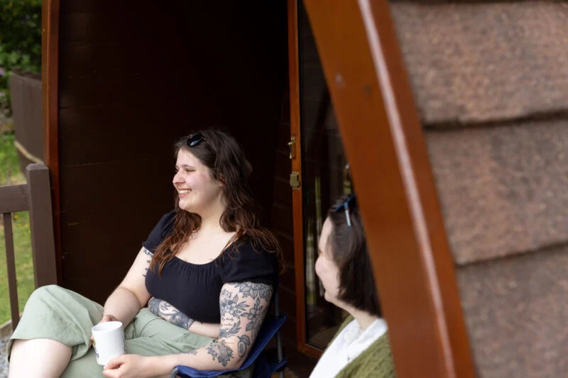 glamping camping pod at windermere ladies sitting outside on decking